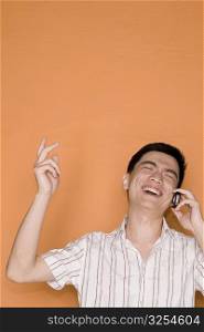 Male office worker talking on a mobile phone and laughing