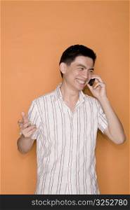 Male office worker talking on a mobile phone and smiling