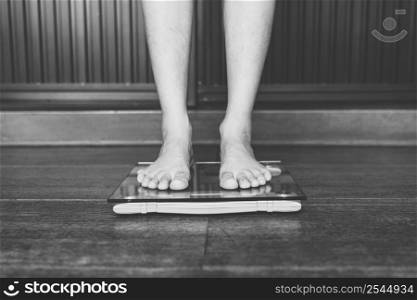 Male on weight scale on floor background, Diet concept.