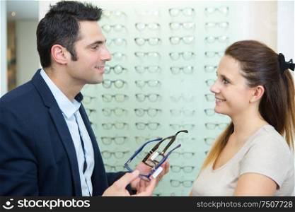 male ophthalmologist and female patient in optics store