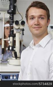 Male Optician Giving Female Patient Eye Examination