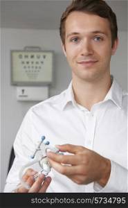 Male Optometrist Giving Patient Sight Test