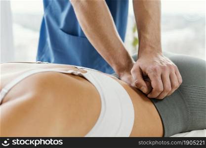 male osteopathic therapist checking female patient s lower back spine. Beautiful photo. male osteopathic therapist checking female patient s lower back spine
