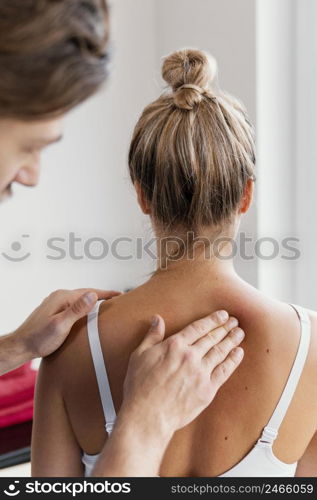 male osteopathic therapist checking female patient s spine