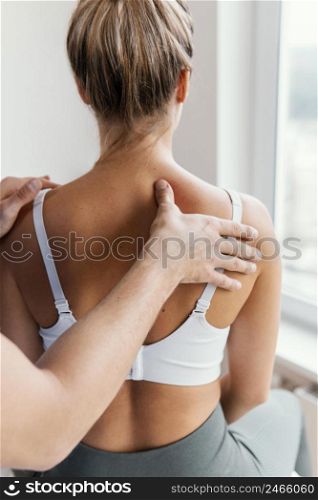 male osteopathic therapist checking female patient s upper spine