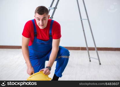 Male painter preparing for painting job at construction site