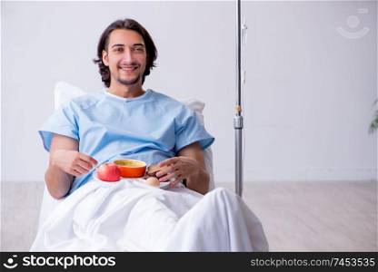 Male patient eating food in the hospital