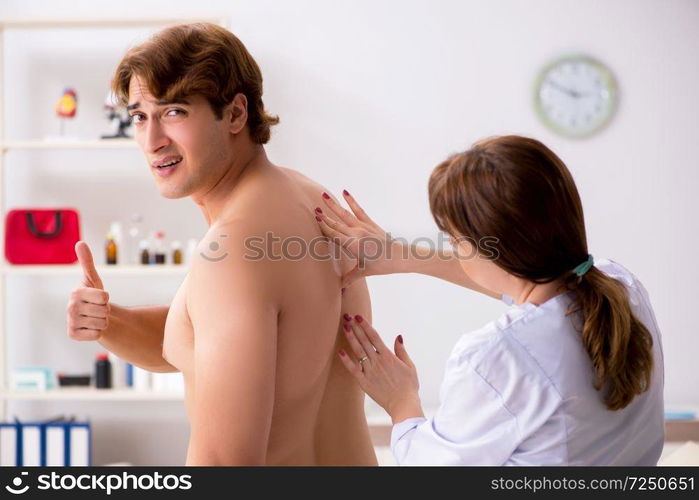 Male patient getting treatment at home. Young female doctor chiropractor massaging male patient