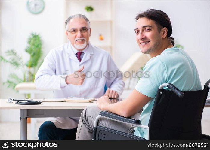 Male patient in wheel-chair visiting old doctor 