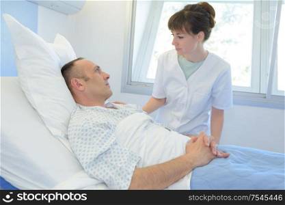 male patient talking to female nurse in emergency room