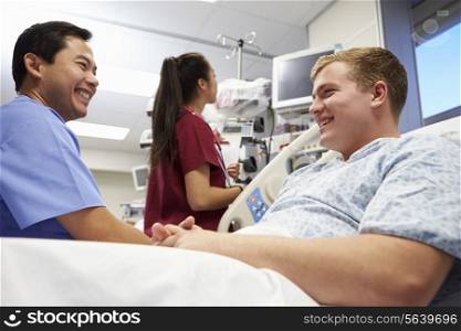 Male Patient Talking To Medical Staff In Emergency Room