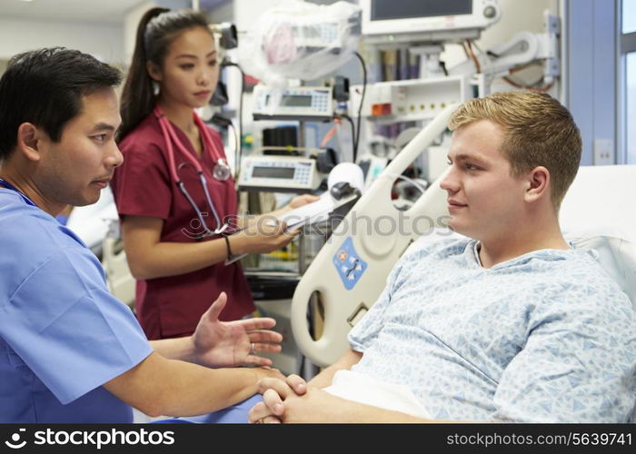 Male Patient Talking To Medical Staff In Emergency Room