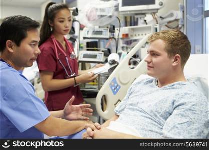 Male Patient Talking To Medical Staff In Emergency Room