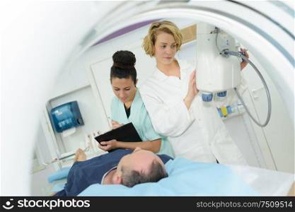 male patient undergoing test at ct scanner machine