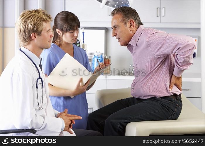 Male Patient Visiting Doctor&#39;s Office With Back Ache