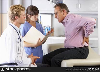 Male Patient Visiting Doctor&#39;s Office With Back Ache