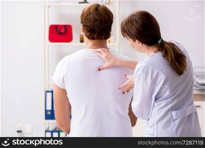 Male patient visiting young female doctor chiropractor