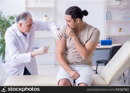 Male patient visitng doctor for shot inoculation 