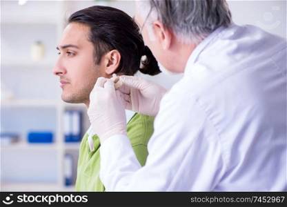 Male patient with hearing problem visiting doctor otorhinolaryngologist . Male patient with hearing problem visiting doctor otorhinolaryng