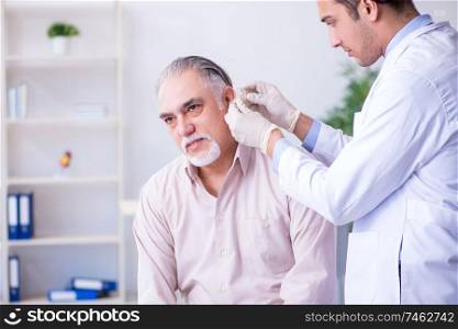 Male patient with hearing problem visiting doctor otorhinolaryngologist . Male patient with hearing problem visiting doctor otorhinolaryng