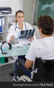 male patient with talking to doctor about xray
