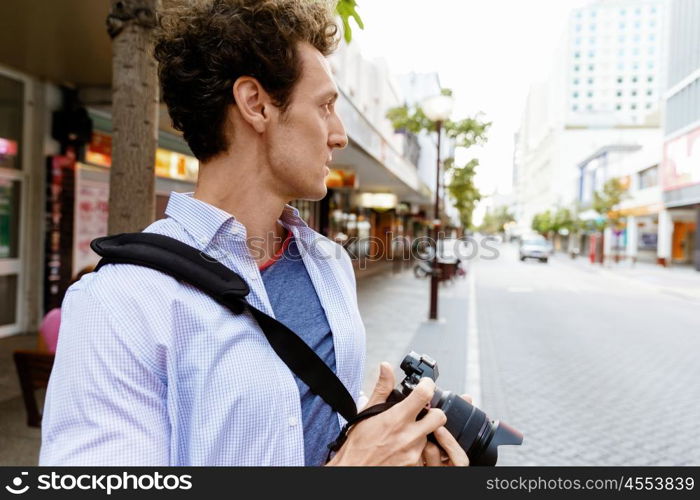 Male photographer taking picture. Professional photographer taking picture in city