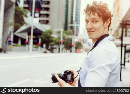 Male photographer taking picture. Professional photographer taking picture in city