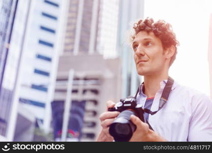 Male photographer taking picture. Professional photographer taking picture in city