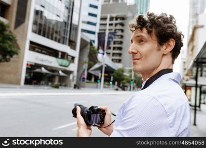 Male photographer taking picture. Professional photographer taking picture in city