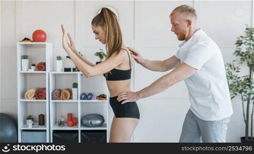 male physiotherapist checking woman s balance
