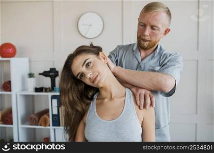 male physiotherapist doing treatment exercises with female patient