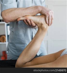 male physiotherapist female patient during massage session