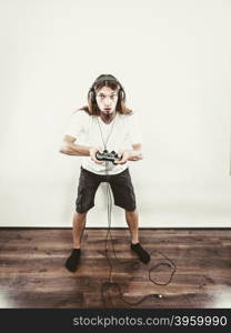 Male player focus on play games. Lifestyle of young people. Student man spending time on playing games videogames console playstation. Long haired guy focus on gaming.