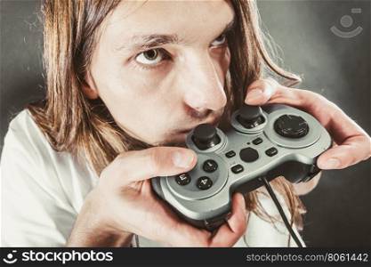 Male player focus on play games. Lifestyle of young people. Student man spending time on playing games videogames console playstation. Long haired guy focus on gaming.