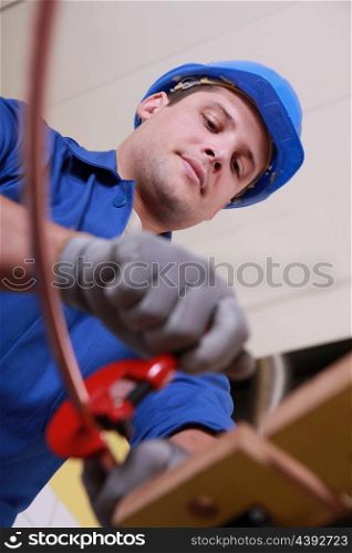 Male plumber using clamp
