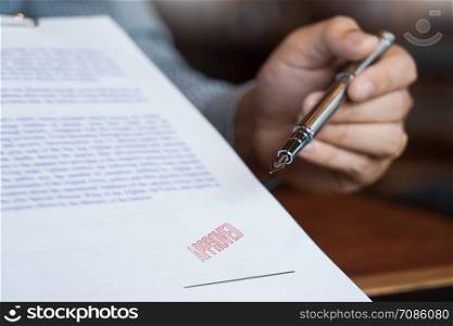 male point to signing business document for putting signature, fountain pen and approved stamped on a document, certificate contract agreement lawyer hand concept