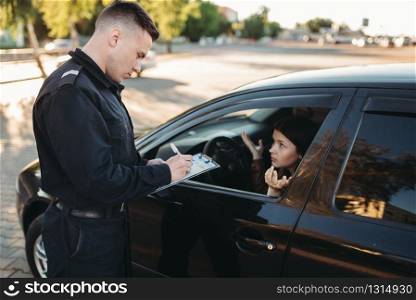 Male police officers in uniform check vehicle on the road. Law protection, car traffic inspector, safety control job. Male police officers check vehicle on the road