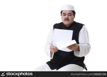 Male politician reading documents over white background
