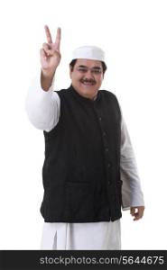 Male politician showing a peace sign over white background