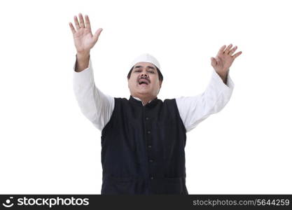 Male politician with hands raised