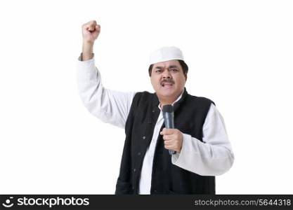 Male politician with microphone making a fist