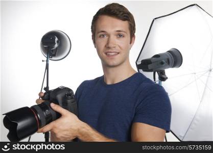 Male Professional Photographer Working In Studio