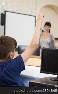 Male Pupil Answering Question In School Classroom