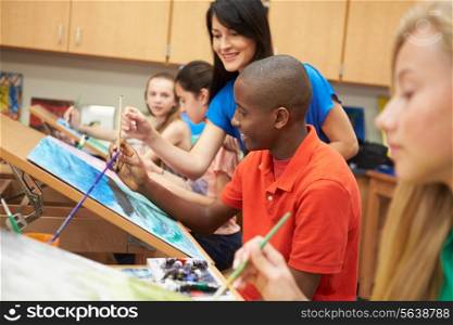 Male Pupil In High School Art Class With Teacher
