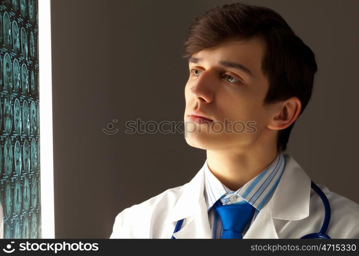 Male radiologist. Image of male radiollogist with x-ray results