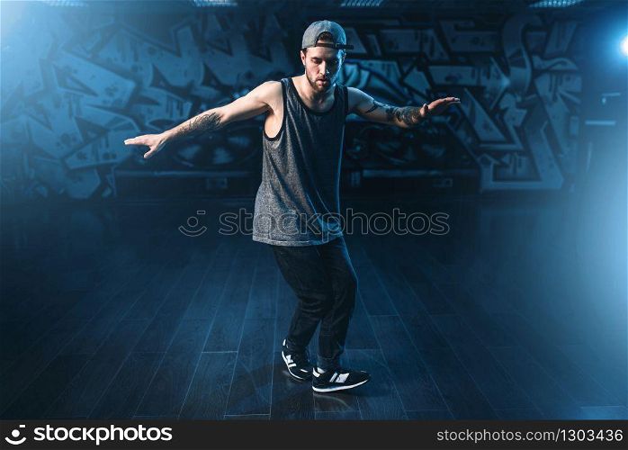 Male rapper in dance studio, trendy lifestyle. Modern urban dancing style. Male rapper in dance studio, trendy lifestyle