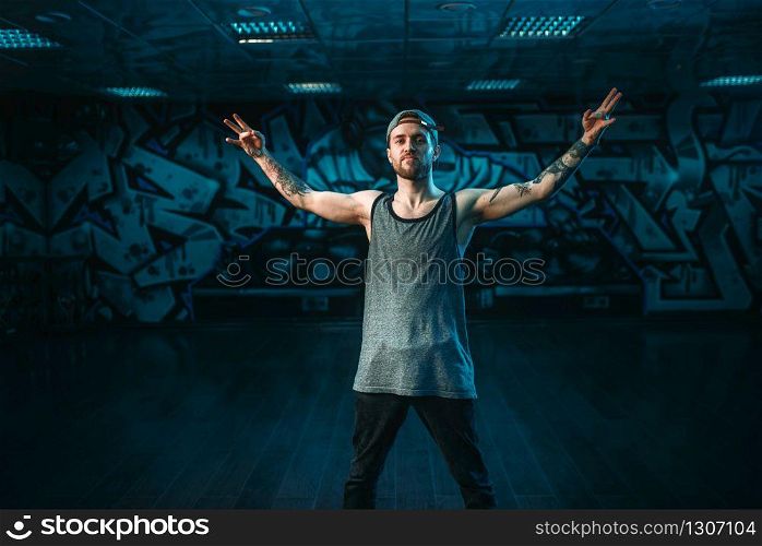 Male rapper in dance studio, trendy lifestyle. Modern urban dancing style. Male rapper in dance studio, trendy lifestyle