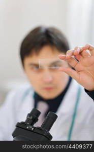 Male researcher checking sample