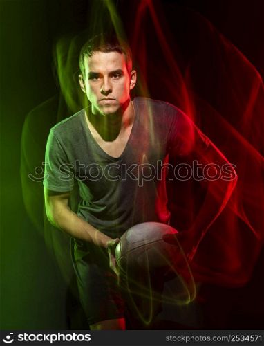 male rugby player holding ball with color effect