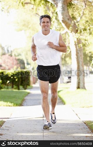 Male Runner Exercising On Suburban Street